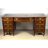 An Edwardian mahogany bow fronted desk, attributed to Gillows, Lancaster,