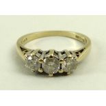 A 9ct gold and diamond three stone ring, the central larger stone of approximately 0.