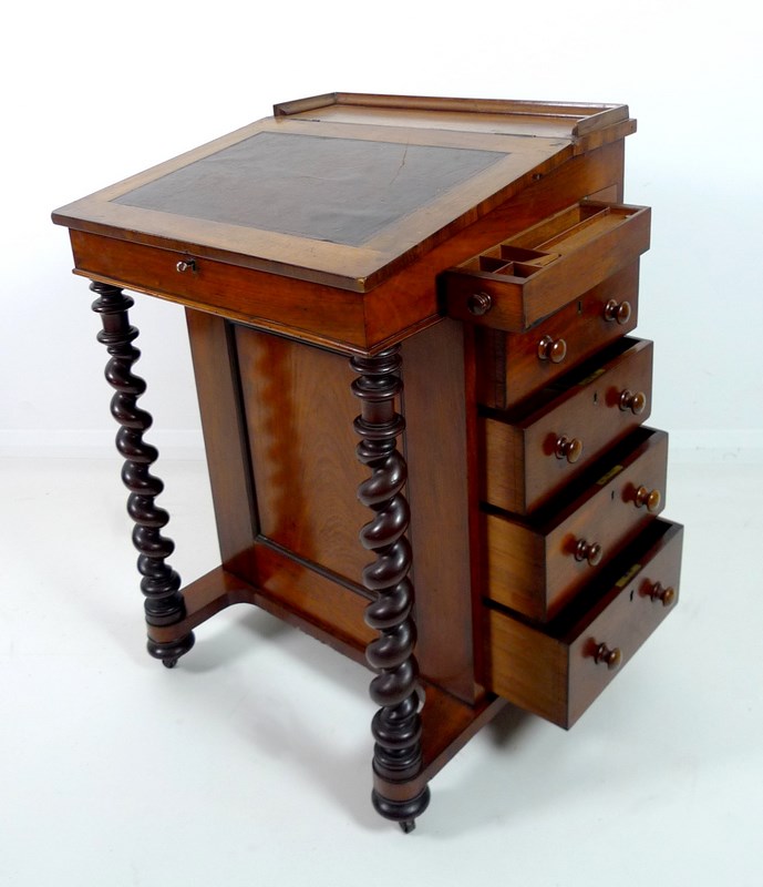 A Victorian mahogany Davenport desk, with barley twist supports brown leather slope,