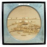 A pair of Chinese circular cork work reliefs, depicting houses and bridges,