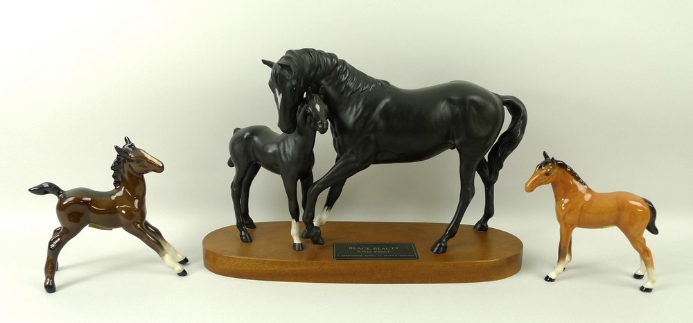 A Beswick figure of Black Beauty and foal, on a wooden base, 21cm, a gloss brown foal,