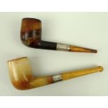 A Meerschaum pipe with silver and amber stem, and another similar, both cased.