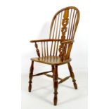 A 19th century Windsor arm chair with vase splat back and H stretcher, 59 by 104cm high.