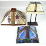 A modern Tiffany style table lamp with stained leaded glass lamp shade, 30 by 18 by 43cm high,