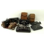 A Kershaw eight-20 Penquin folding camera in a canvas slip case,