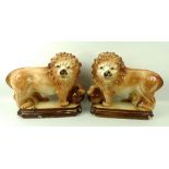 A pair of Staffordshire pottery lions, 19th century, each with glass bead eyes,