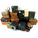 A collection of vintage cameras, including a Kodak Baby Hawkeye camera,