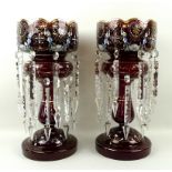 A pair of Bohemian ruby glass lustres, enamelled with floral sprays and hand gilded, circa 1890,