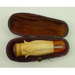 A Meerschaum cigar holder, amber with a petal shaped body, in a fitted case, 6.8cm.