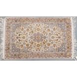 A Nain finely knotted rug, the central medallion on a grey and cream ground, 69 by 113cm.