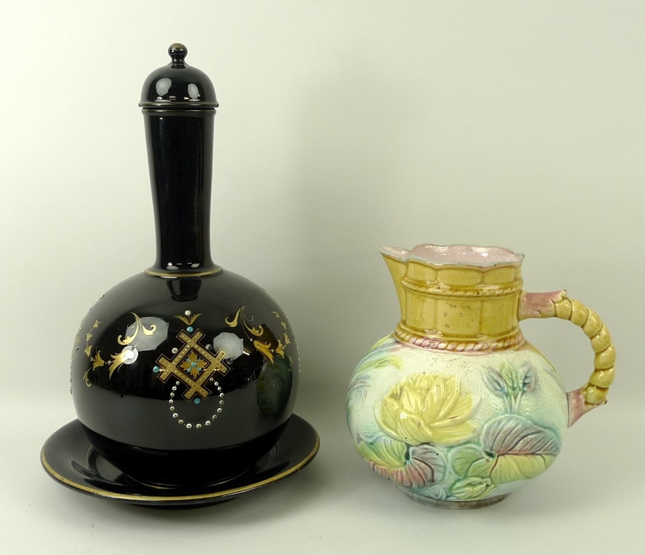 A Jackfield ceramic lidded bottle vase and plate, in black ground with enamel and gilt decoration,