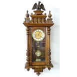 An early 20th century mahogany wall clock with enamel chapter dial,