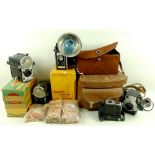 A collection of vintage cameras and equipment, including a Spartus Press Flash camera, 1950's,