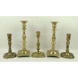 A pair of 18th century brass candlesticks with baluster stems, and square footed bases, 24cm,