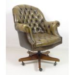 A leather button back Chesterfield style tub office chair, circa 1970,
