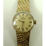 An Omega lady's gold wristwatch, circa 1950s, the circular face with baton numerals,