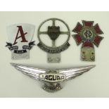 A collection of car badges, comprising 'The Order of the Road', an 'Allard Owners Club' badge,