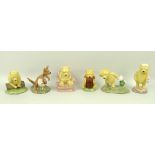 A collection of Royal Doulton Winnie the Pooh figurines, comprising Pooh and Piglet - The Windy Day,