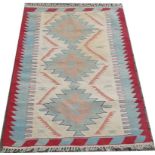 A Kelim, slit tapestry flat weave light rug, with blue medallions on a camel ground,