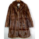 A three quarter length fur coat, by Cairds, Dundee, approx size 12 or 14,