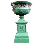 A large aluminium and brass, classical styled urn on a pedestal base,