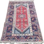 An Afshar blue ground rug, with a red central medallion, 123 by 213cm.