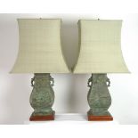 A pair of Chinese bronze table lamps, circa 1975, with shot silk collapsible shades,