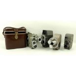 A collection of movie cameras comprising G B Bell & Howell 605 Double Run,