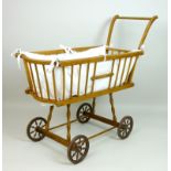 A mid 20th century turned beechwood doll's pram with sleigh handle, 72cm high.