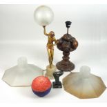 A 1930s Deco figural table lamp the scantily clad dancer holding a globe aloft,