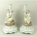 A pair of Dresden figural candlesticks, depicting classical maidens with conical holders,