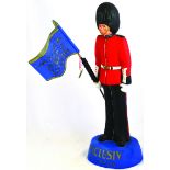 EXCLUSIV PIPE TOBACCOS FIGURE. 20ins tall, rubberoid bearskin wearing soldier with flag, red,