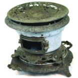 CAST IRON STOVE. 9ins tall, ornate cast iron stove, oil fired with 2 burners, middle section in