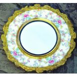 WALL MIRROR. 19ins diam, brass & ceramic framed mirror. Fancy brass edge with coloured floral design