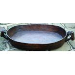 WOODEN TRAY. Oval shape 32ins across to side handles, 5.5ins deep, carved from single piece of