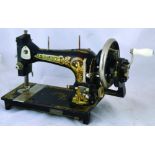 FRISTER & ROSSMAN SEWING MACHINE. 10.5ins tall, cast iron black with gold decoration FRISTER &