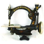 WILLCOX & GIBBS SEWING MACHINE. 10 by 10ins, cast iron black with WILLCOX & GIBBS S. MC. in gold