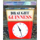 GUINNESS CLOCK. 17ins long, 13.5ins wide at chrome top. Perspex clock face with DRAUGHT/ GUINNESS to