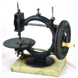 THE WANZER SEWING MACHINE. 11.5ins tall, cast iron on marble base, hand cranked WANZER SEWING