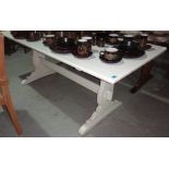 A 20th century white painted rectangular dining table.