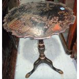 A 19th century chinoiserie decorated black lacquer tripod table.