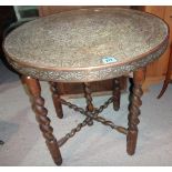 A 20th century brass and wooden circular folding tray table.