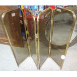 A 20th century brass and smoked glass fire screen.