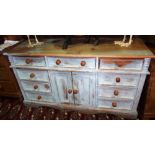 A 20th century painted pine dresser base, with an arrangement of cupboards and drawers.
