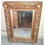 A 20th century heavily moulded gilt framed wall mirror, together with a copper circular mirror (2).