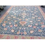 A large 20th century machine made rug of William Morris design.