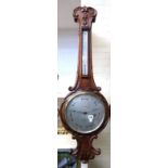 A Victorian oak cased wheel barometer, with all over foliate carving and applied thermometer,