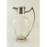 A Victorian silver mounted glass claret jug, the body of oval form,