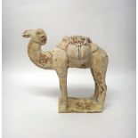 A Tang style pottery bactrian camel, standing foursquare with saddle bags across its back,