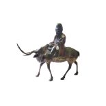 A polychrome painted bronze figure of a sage riding atop a reindeer, 19th century, 60cm high.